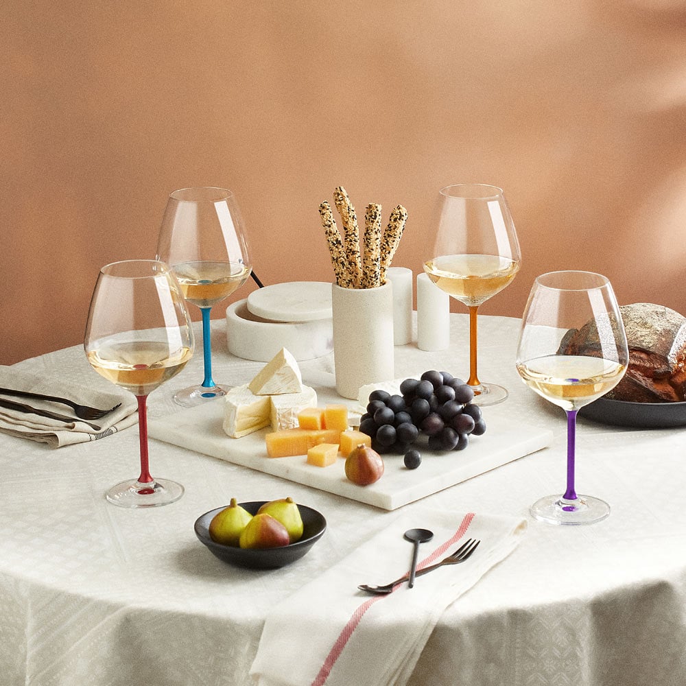 Interior table styling photoshoot with wine glasses and food accessories