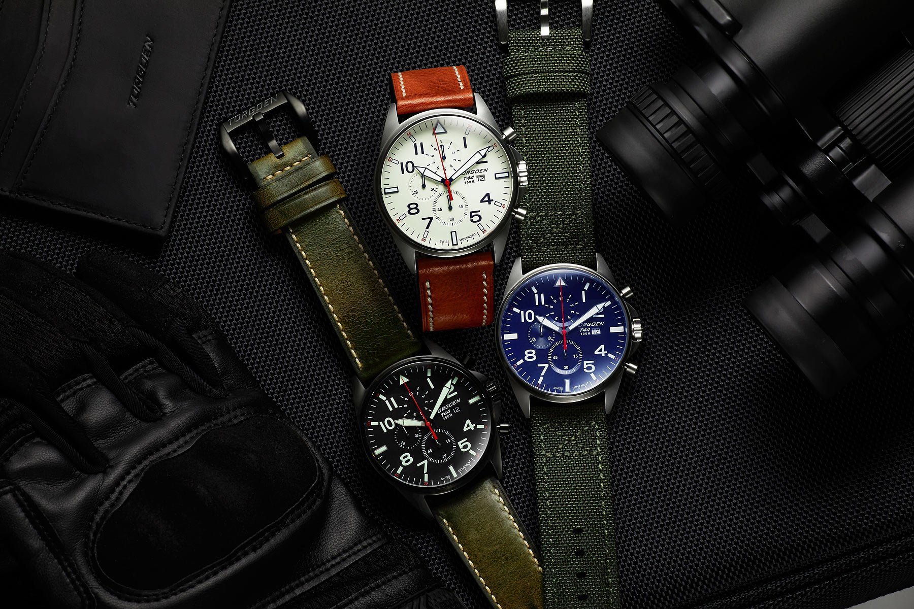 Set of three men watches photoshoot with props